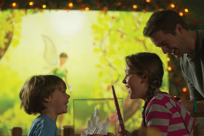 A young girl, her brother and dad having fun at the Pixie Encounter adventure